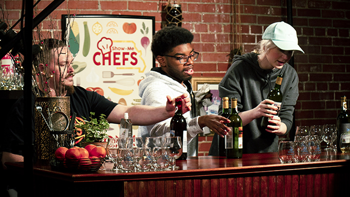 Field Host Joey Fiddick and two students on Art Department set up the Show-Me Chefs Pairings Corner on promo day.