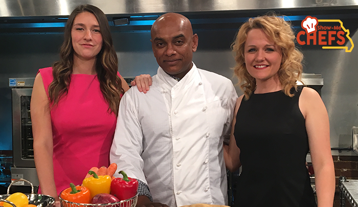 Chef Angelo poses in the kitchen with Season 3 host and field host